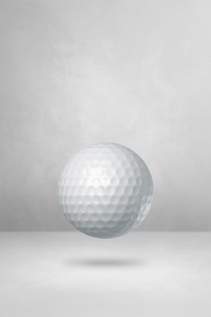 White golf ball isolated on a blank studio background.