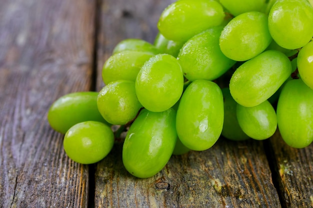 White grapes on a wooden table juicy ripe grapes on a wooden board