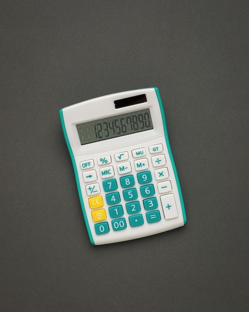 White and green calculator on a dark gray background