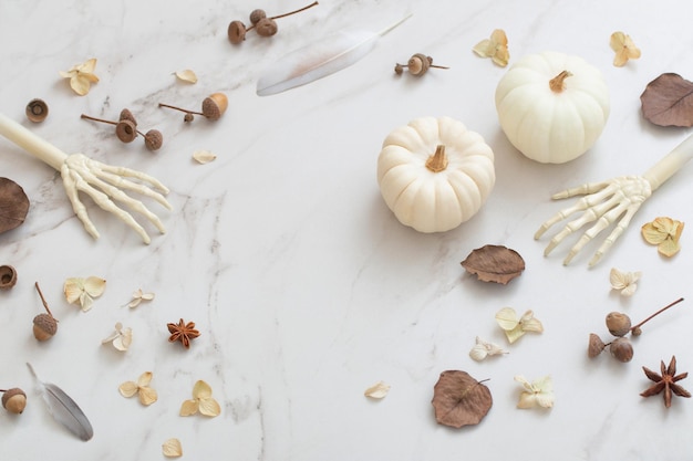 White halloween pumpkins with decor on marble background