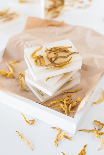 White handmade soap bars with yellow sunflower petals