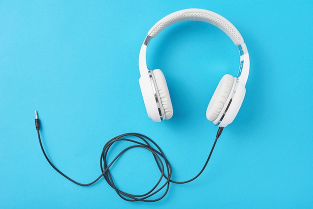 White headphones on a pastel blue background