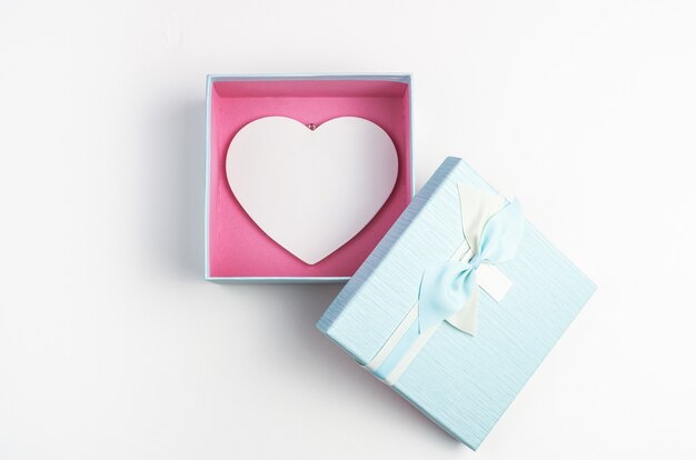 White heart in a blue box with an open lid on a white background.