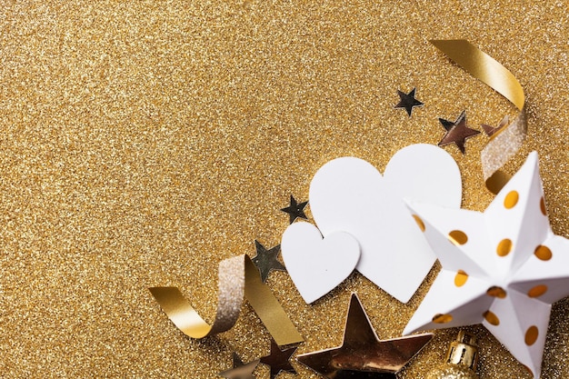 White heart shape on a golden glitter backgrond