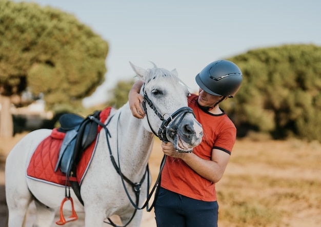 White horse enjoying the pampering of its young owner