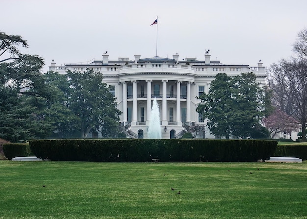 White house lawn and fountain in Washington, DC with gray sky