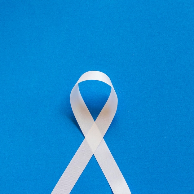 White January mental health awareness campaign white ribbon on blue background