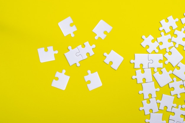 White jigsaw puzzle on a yellow background