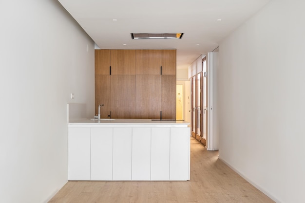 White kitchen interior with wooden furniture and kitchen island