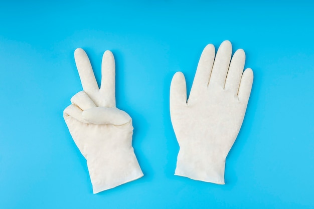 White latex gloves. Protection concept. With proper protection you beat the virus.