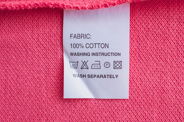 White laundry care washing instructions clothes label on cotton shirt