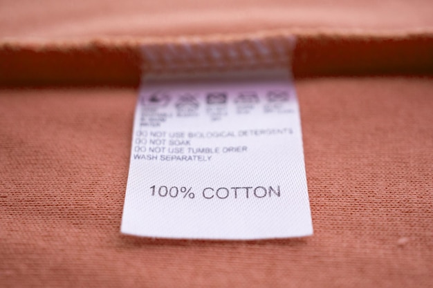 White laundry care washing instructions clothes label on cotton shirt