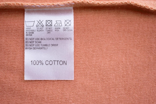 White laundry care washing instructions clothes label on cotton shirt