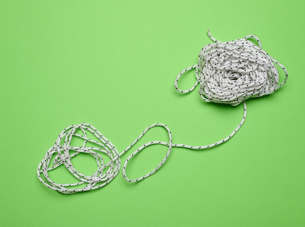 White laundry rope on a green background top view