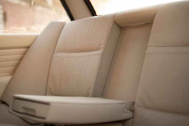 A white leather car interior inside the vintage old vehicle