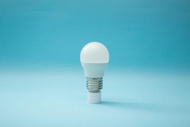 White light bulb on a blue background