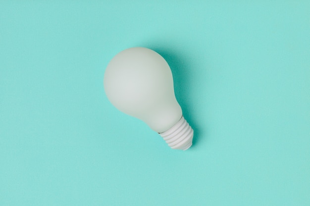 White light bulb on blue background