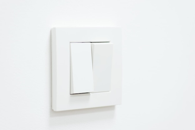 White light switch on white wall