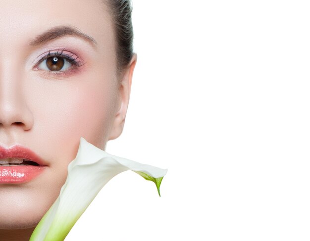 White lily flowers and young woman face closeup isolated on white background