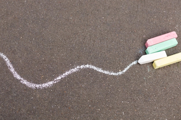 White line painted on a road with chalk Color chalk for drawing outdoor