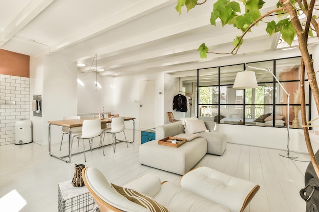 A white living room with a couch and a table