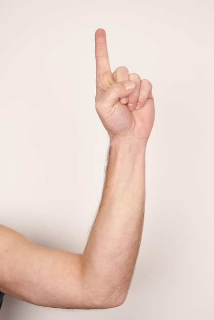 White male hand showing showing number one and up on a white isolated background.