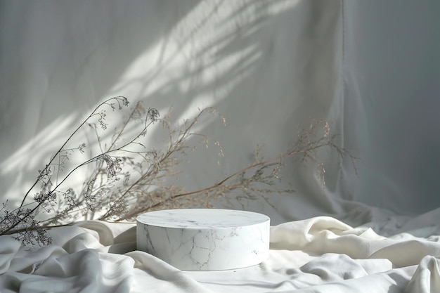 White marble podium on a white background with dried flowers and plant shadows