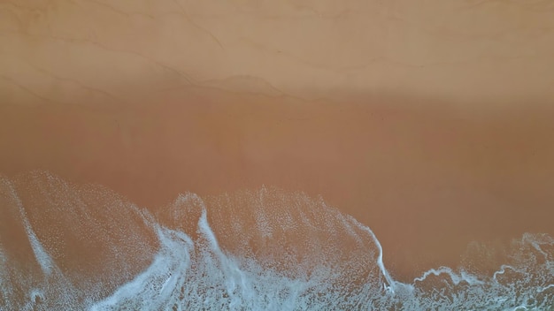 White marine foam washing sand close up stormy sea foaming at shallow beach