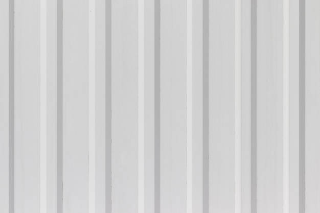 White metal wall or fence with vertical corrugated stripes