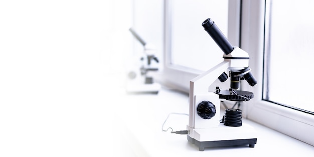 a white microscope on the table a scientific laboratory laboratory of medical sciences look through