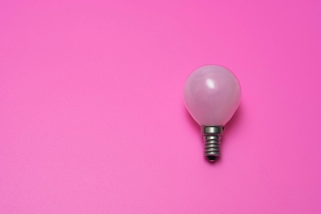 White minion light bulb on pink background