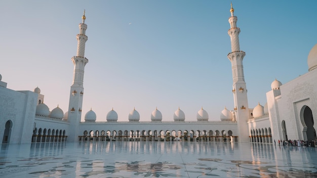 A white mosque with a blue sky in the background