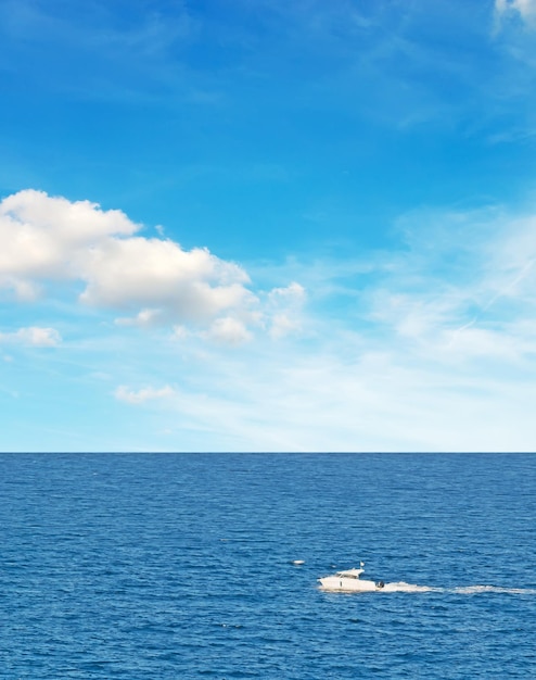 White motorboat cruising in the sea