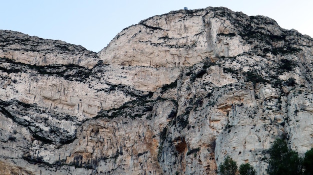 White mountain, sheer cliffs, stones, mountain vegetation, pine trees, beautiful unique landscape,