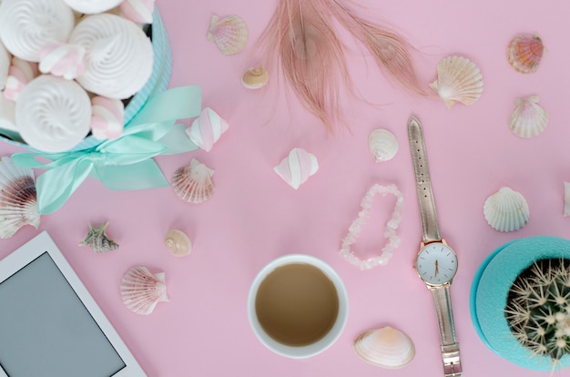 White mug with beverage. Flat lay concept. Objects on the table. Girly style.