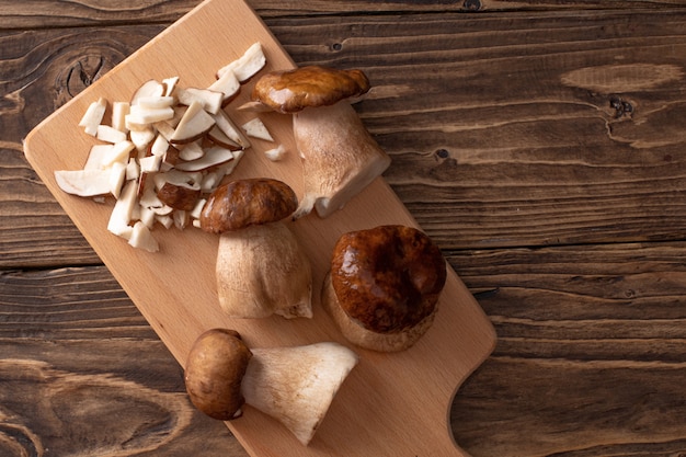 White mushrooms on a wooden table, partially chopped. natural mushroom from the forest.