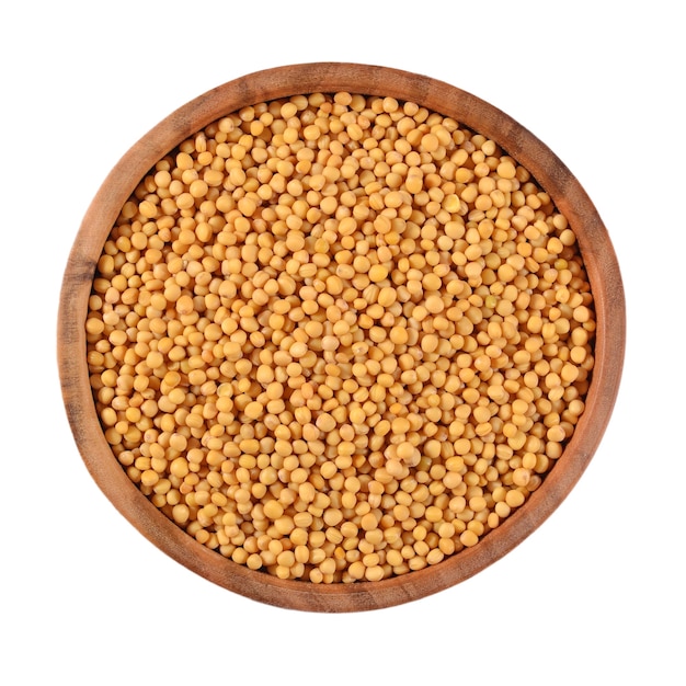 White mustard seeds in a wooden bowl on a white background