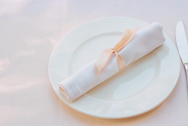 White napkin on the plate on the table Cutlery food lunch party concept