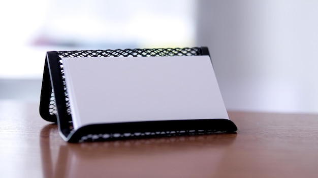 A white notepad sits on a table with a white paper that says'i love you '