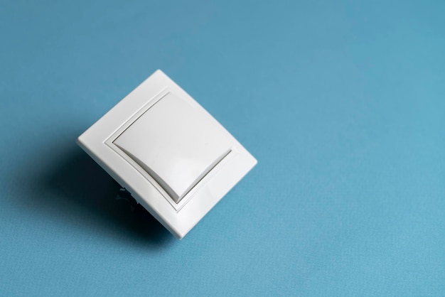 A white on and off electric light switch at home