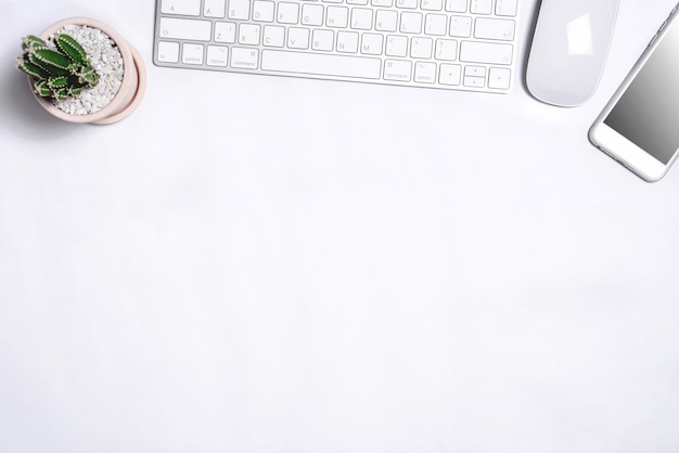 White office desk table with a lot of things on it. Top view with copy space