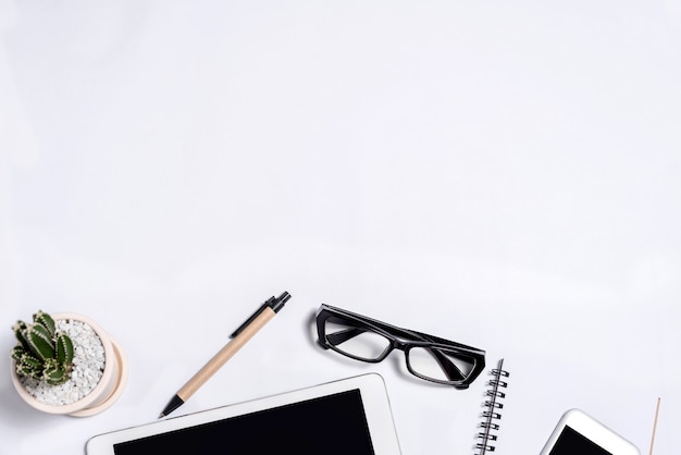 White office desk table with a lot of things on it. Top view with copy space