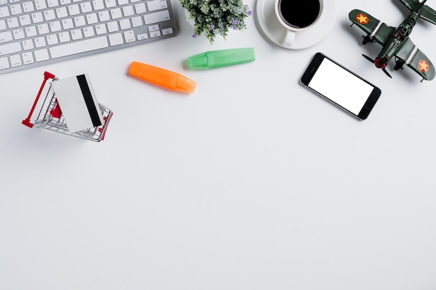 White office desk with computer keyboard, notebook and supplies