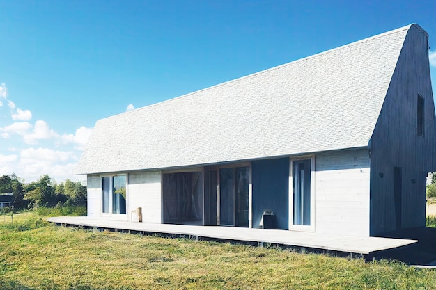 White onestorey house in middle of lawn scandinavian style house exterior