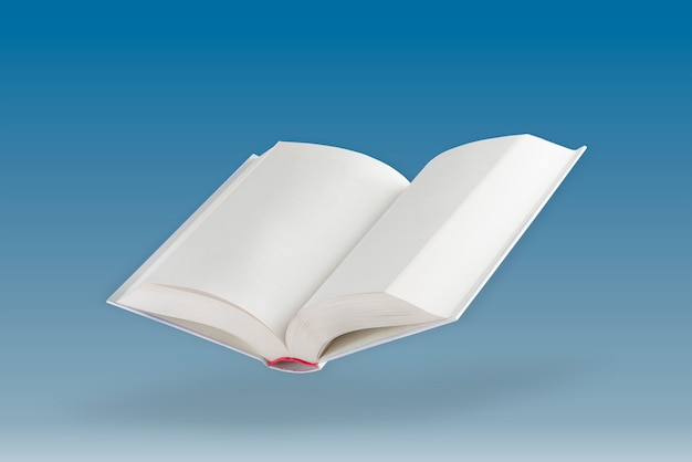 White open book a blank white book floats in the air casting a shadow against a blue background blan...