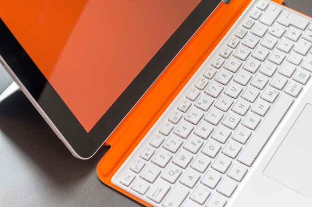 White orange convertible laptop and keyboard