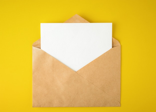 White paper card in an envelope on yellow background