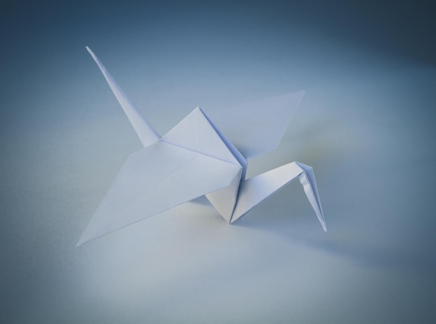 White paper crane origami isolated on blank background