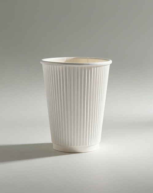 a white paper cup with a brown design on the bottom