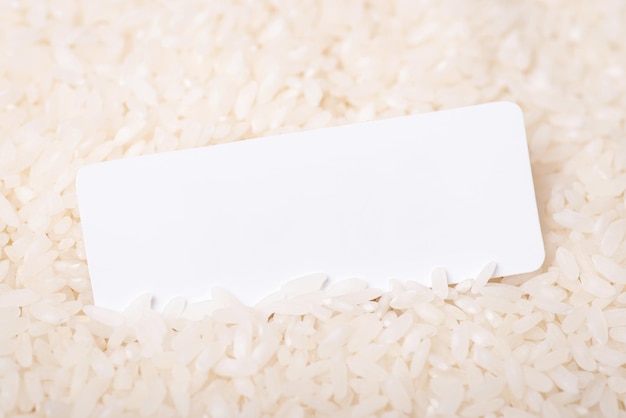 Photo white paper in rice with copy space blank paper for inscription in rice